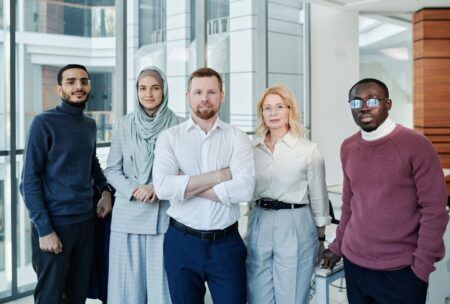 a group of young individuals exuding confidence, standing in an office, representing confidence in work