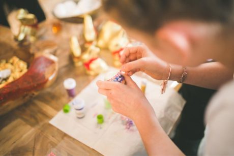 a woman skillfully crafts with colorful beads, showcasing creativity and inspiration Etsy for beginners