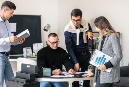 a scene of business people working together, emphasizing strategies on how to hold their team accountable effectively