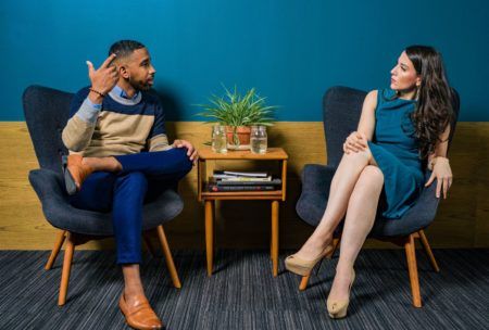 a man and woman discussing how to become a social worker while sitting in chairs