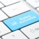 white keyboard with a blue key labeled sales success