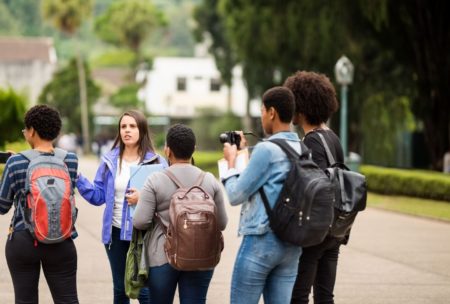 female tour guide talking to a group of young people