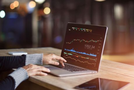 a determined individual analyzing stock market data, symbolizing a trading mindset