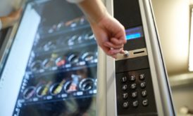 woman pressing buttons on a vending machine