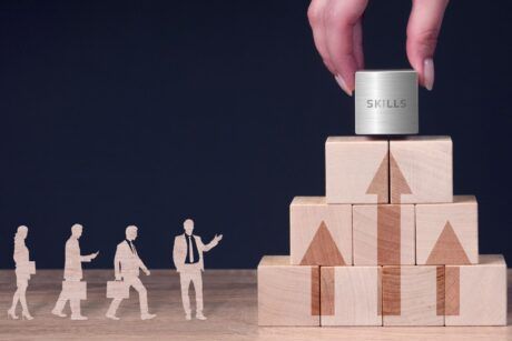 A person places a wooden block with a sign, illustrating the concept of workplace readiness skills in a professional setting